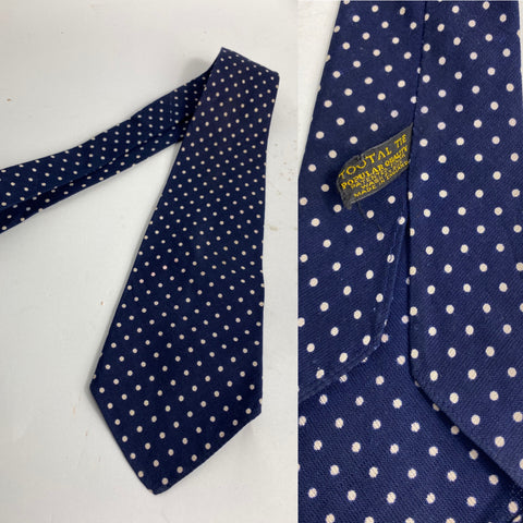 1940s Tootal tie popular quality label in yellow font, navy blue and white polka dot. No lining and open backs with short blade at 114cm long 9cm wide. No damage.