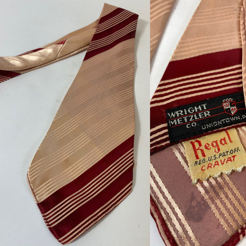 1940s US swing tie in pink and maroon stripes. REGAL RES US PAT. No lining and open backs with short blade at 120cm long 10cm wide. No damage.