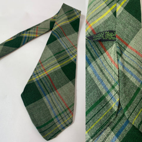 1940s Tootal tie in green quality label. Green red and blue plaid pattern. No lining, open backs and short blade at 120cm long and 9 cm wide. No damage.