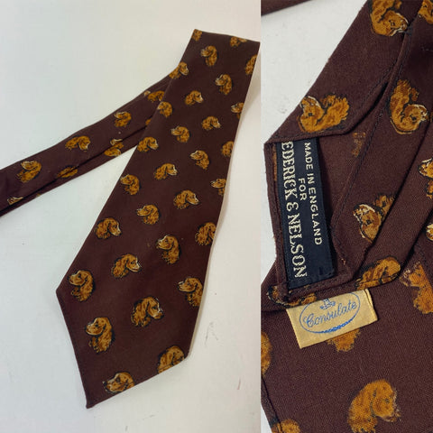 1940s tie consulate all wool for Frederick & Nelson made in England. Brown with stunning repeat pattern of spaniel dog. No lining and open backs with short blade at 125cm long and 8cm wide.