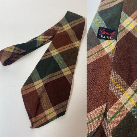 1940s Grenville tie pure wool. Dark brown and rust with teal and yellow plaid pattern. Open backs, no lining and short blade at 120cm long 9cm wide. No damage.