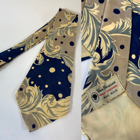 1940s US tie swing all silk, Van Heusen in ivory/white with dark blue and pale lilac with organic and spotted pattern. Open backs with short blade at 126cm long and 11cm wide. No damage