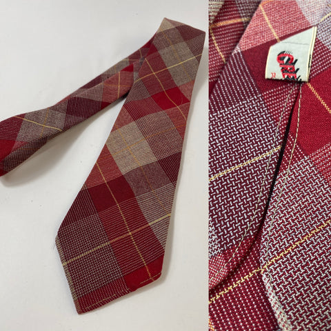 1940s Grenville tie in red, grey and yellow plaid pattern. No lining and open backs with short blade at 122cm long and 8cm wide. No damage.