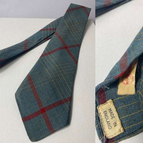 1940s tie wool, cashmere made in England. Greyish teal colour with red and yellow box check. No lining and open backs with short blade. Small hole to right of front tip.