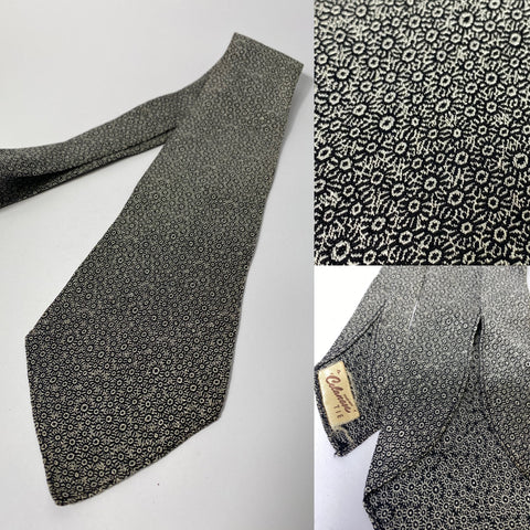 1940s silk tie Celanese, dress/morning suit attire. Silver and black subtle design with lines and circles. No lining, open backs and short blade at 120cm long 10cm wide. No damage.