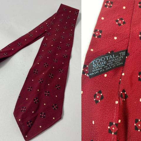 1940s Tootal tie in blue quality label, red with black and cream repeat pattern. No lining and open backs with short blade at 120cm long and 9 cm wide. No damage.