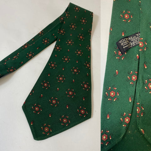 1940s Tootal tie in sports quality label. Bottle green with red motif pattern. No lining, open backs and short blade at 120cm long and 9cm wide. No damage.
