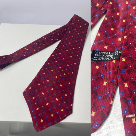 Tootal tie in Black Quality label in red with cream and blue repeat pattern. Open backs and Short blade at 125cm 9cm wide. No damage.