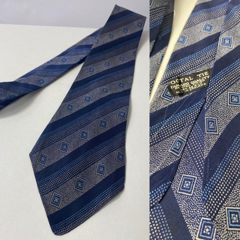 1940s Tootal tie in popular quality label. Blue multi stripe, no lining and open backs with short blade at 118cm long 9cm wide. No damage.