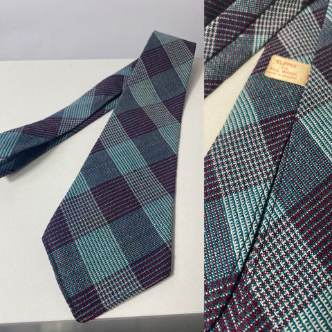1940s Klipper tie in teal and red plaid pattern. No lining and open backs with short blade at 124cm long and 9cm wide. No damage.