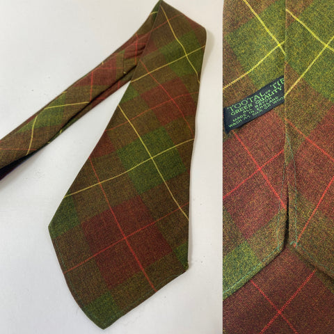 1940s Tootal tie in green quality label in green brown red and yellow plaid pattern. No lining and open backs with short blade at 122cm long and 9cm wide. No damage.
