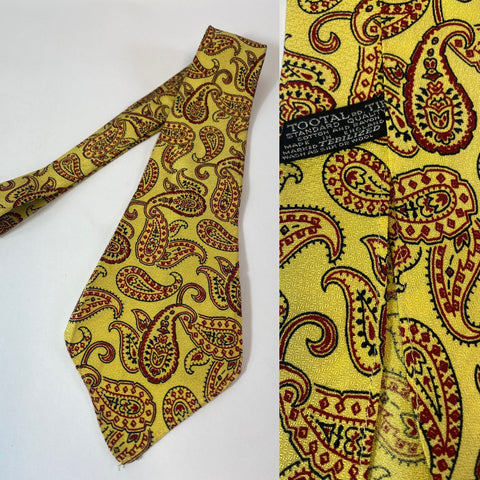 1940s Tootal tie standard quality in yellow with red and black paisley pattern. No lining and open backs with short blade at 125cm long and 10cm wide. No damage.