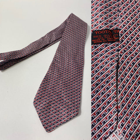 1940s Tootal tie in red quality label. Red blue and and white block,  geometric pattern. No lining and open backs with short blade at 120cm long and 8cm wide. No damage.