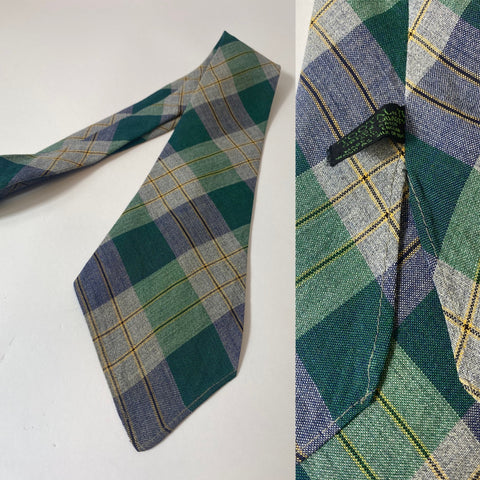 1940s Tootal tie in green quality label. Teal green and grey plaid pattern. No lining, open backs and short blade at 120cm long 10cm wide. Tiny pull on thinner end at tip.