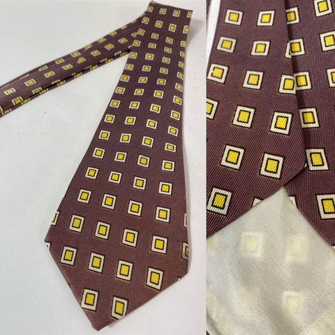 1940s/50s US swing tie in greyish purple with yellow and white square pattern. Lined with open backs and fairly short blade at 130cm 9cm wide. No damage.