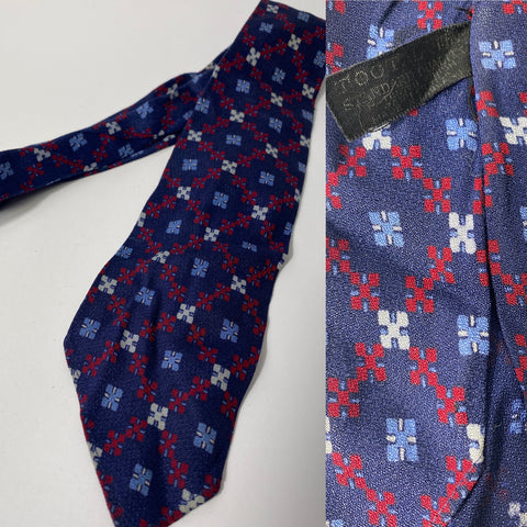 1940s Tootal tie popular quality label  in navy blue with red white and sky blue Argyl, cross pattern. No lining and open backs and short blade at 110cm long and 8cm wide. No damage.
